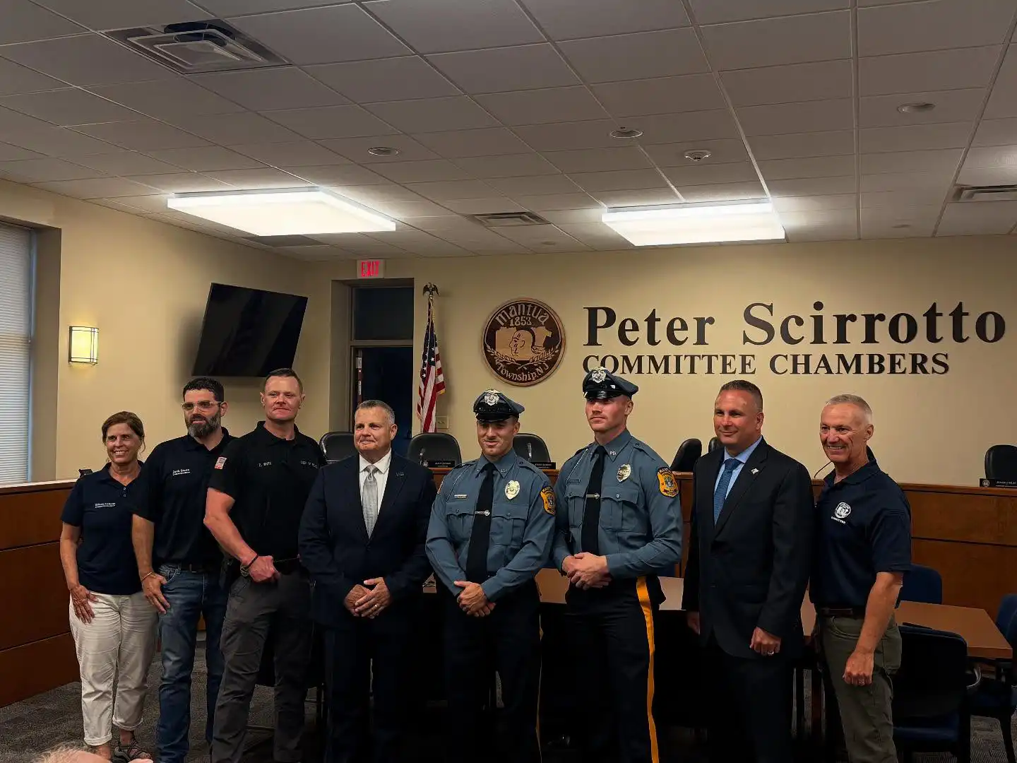 New Mantua Township police officers being sworn in at Township Committee meeting with dignitaries