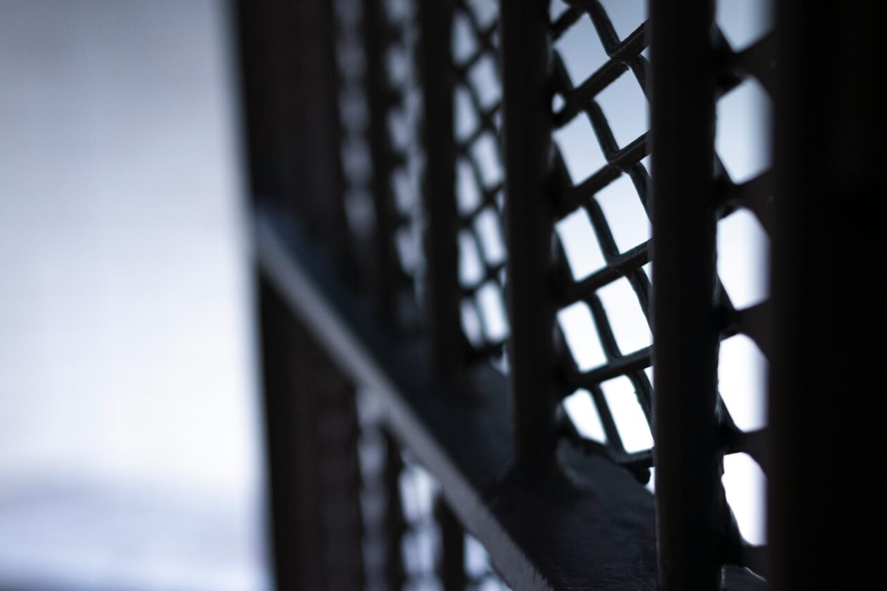 Interior view of jail cell with metal bars